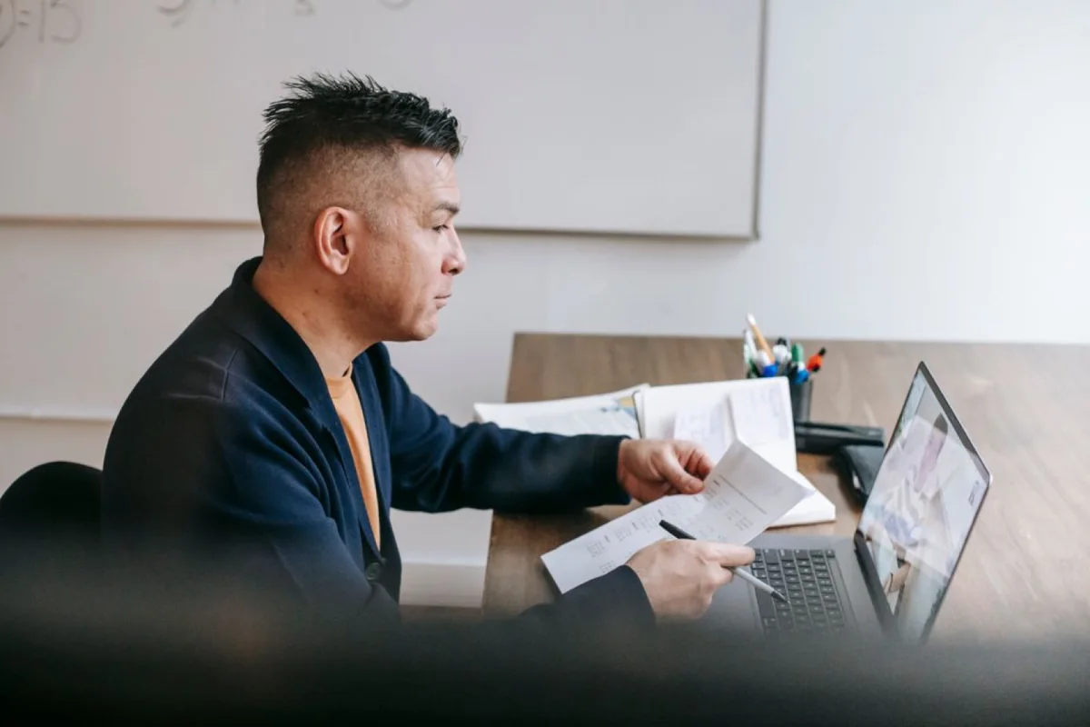 Professional discussing project documents during a video call